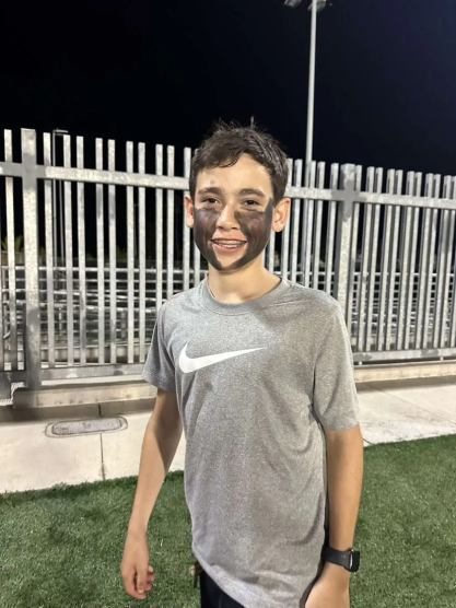 Student JA wearing face paint to a football game