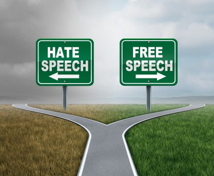 Free speech and hate speech road signs at a fork in the road
