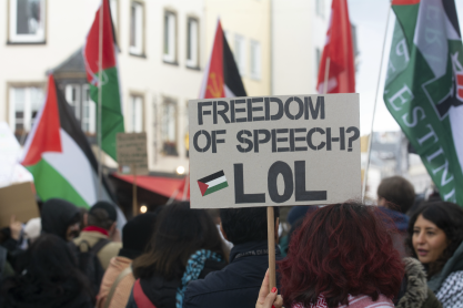 Protester is holding a placard that reads ''Freedom of Speech'' while nearly a hundred people are participating in a demonstration to commemorate Palestinian Prisoners Day in Bonn, Germany copy