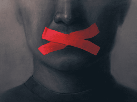 An illustration of a persons mouth with red tape in an X over their mouth. 