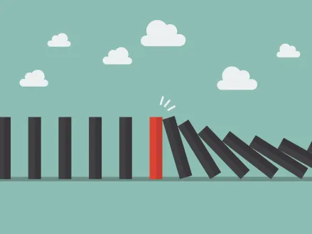 Red domino among many black dominoes falling over in a chain reaction