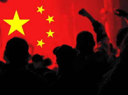 Silhouette of protesters against Chinese flag