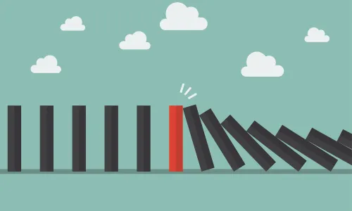 Red domino among many black dominoes falling over in a chain reaction