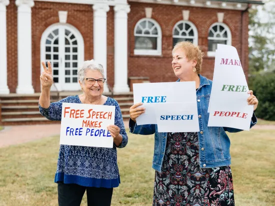 Barbara Piercy (left) and Rita Annan-Brady hold signs reading "Free Speech" in West Caldwell, New Jersey