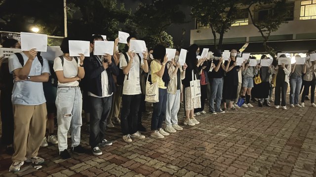 Protesters hold up blank white papers in China