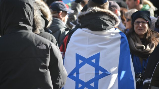 Man wearing the flag of the state of Israel at a public protest in New York City on Jan. 5 2020