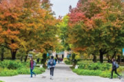 College campus with students walking outdoors on a path