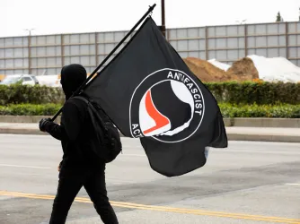Los Angeles May 2021 - An Antifa member carries a flag during a protest