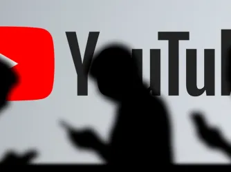 YouTube sign with people walking by